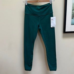 Elation 7/8 tight in a jade green new with tags size extra small